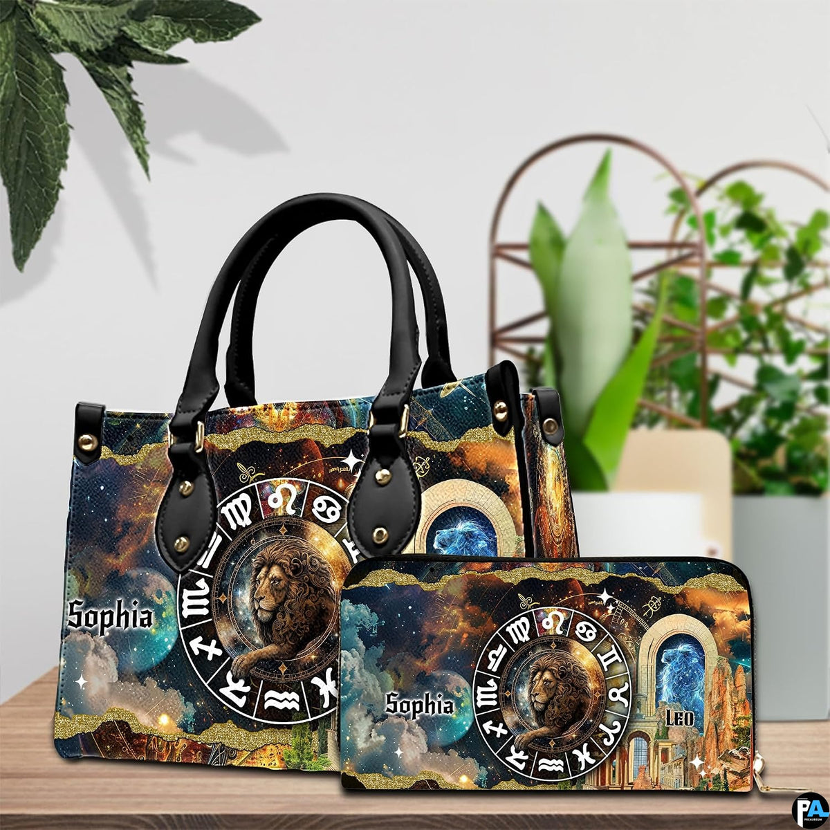 Celestial Lion Satchel Handbag and continental wallet set shown on a wooden table beside greenery.