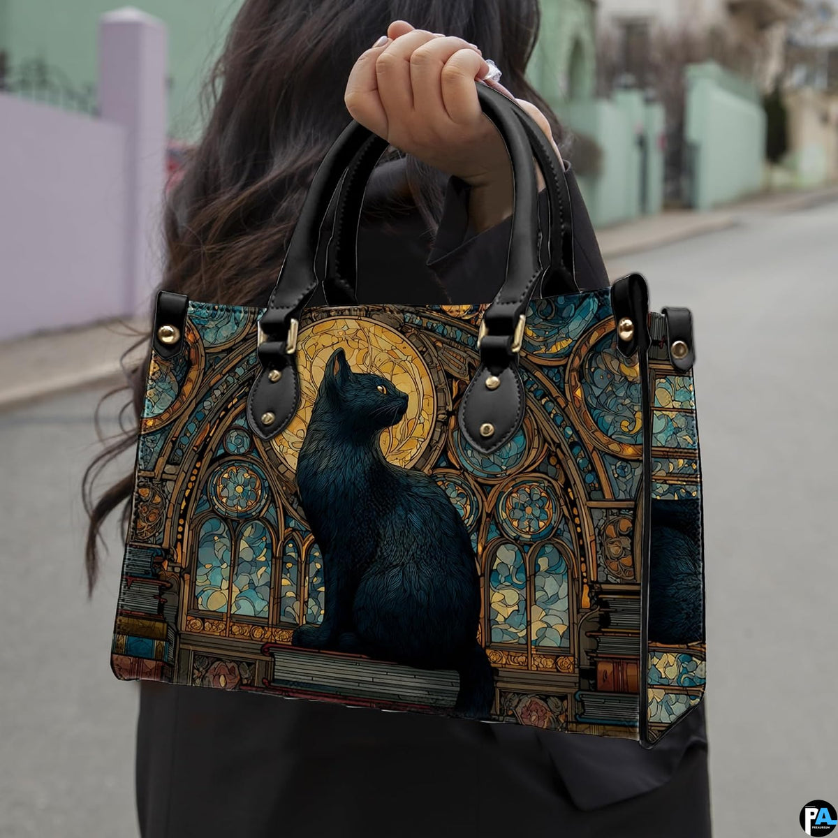 Black cat full moon gothic cathedral artwork held outdoors along a sunlit city walkway.