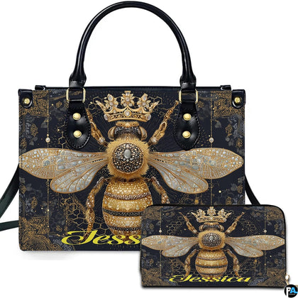 Front view of crowned queen bee handbag and matching wallet set with golden filigree artwork.