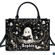 Front product view of structured satchel displaying monochrome reading ghost and bookish spirits artwork.