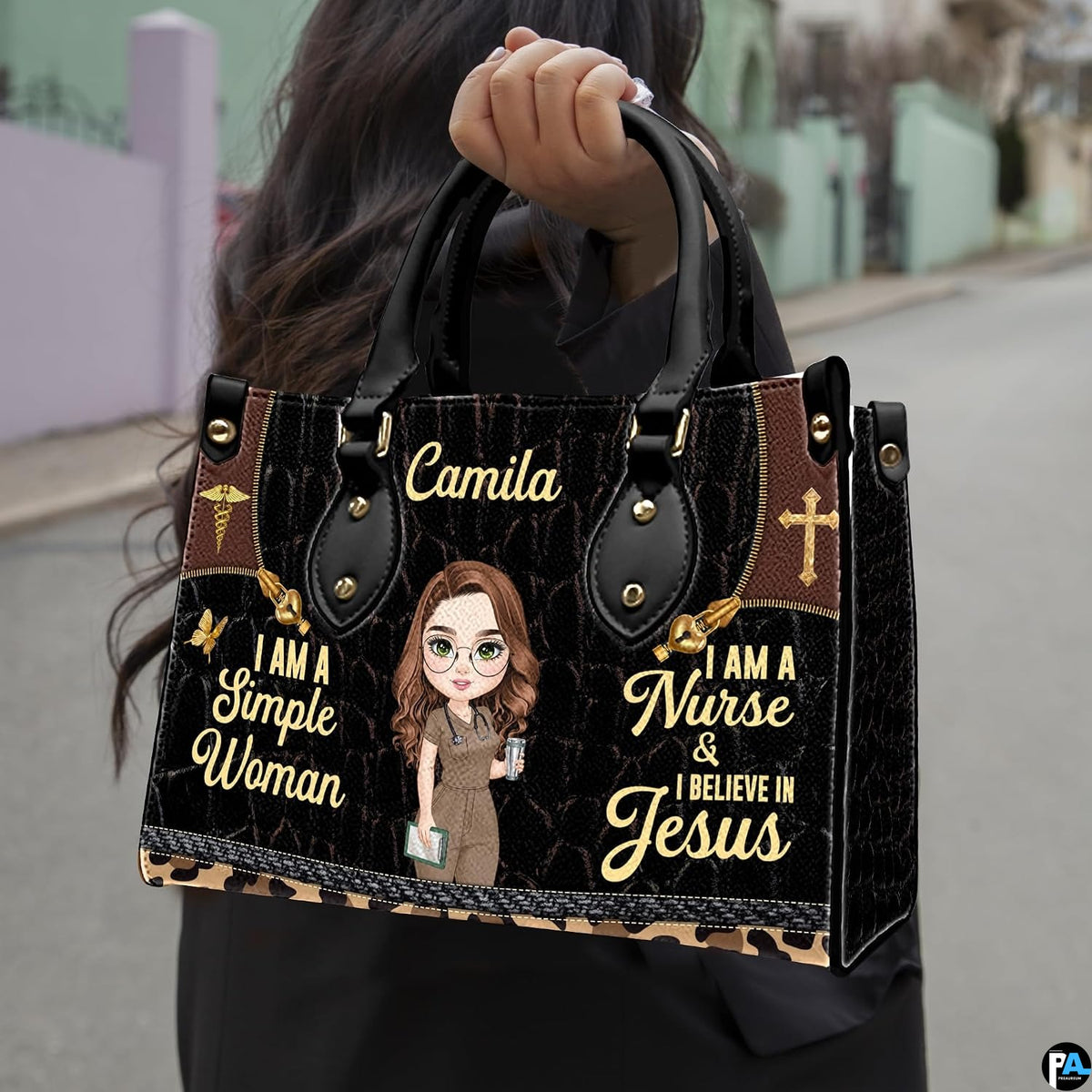 Christian nurse handbag held outdoors showing visual scale against street setting.