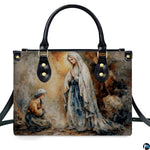 Handbag displayed outdoors in daylight showing soft impressionist Lourdes artwork.
