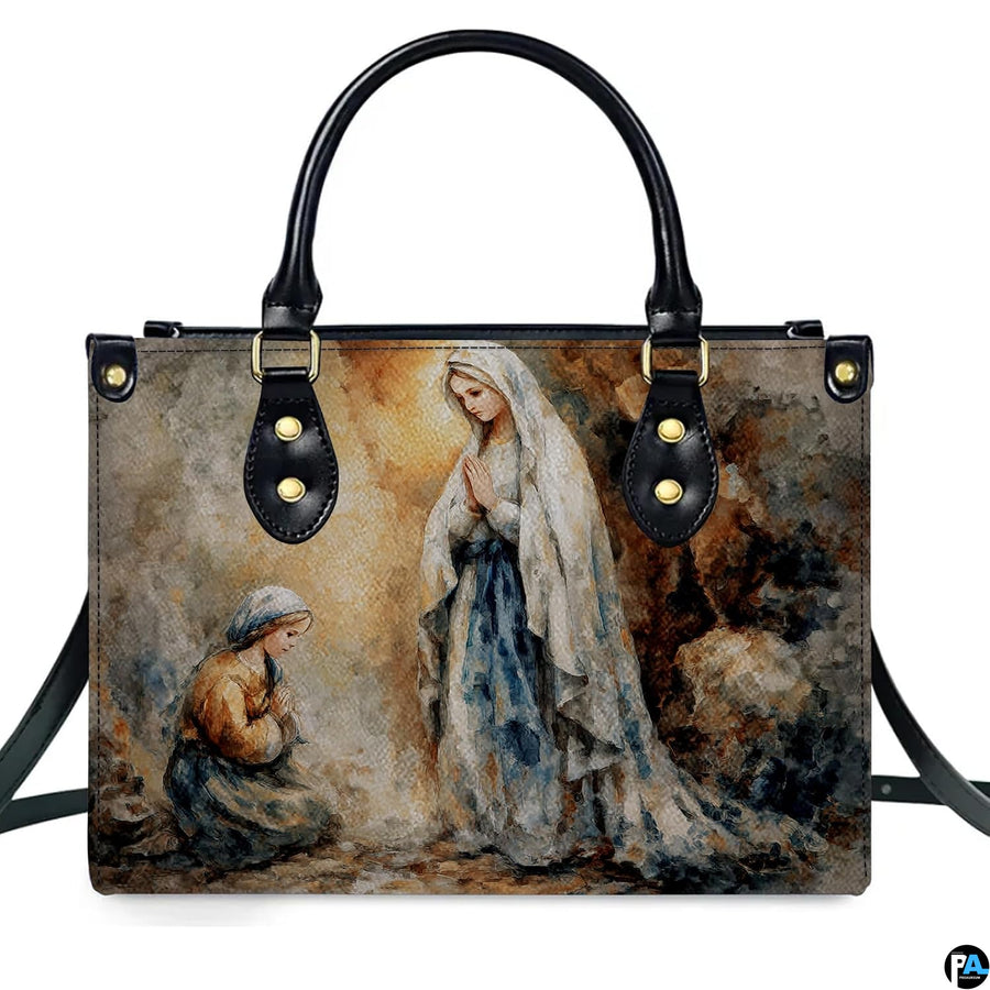 Handbag displayed outdoors in daylight showing soft impressionist Lourdes artwork.
