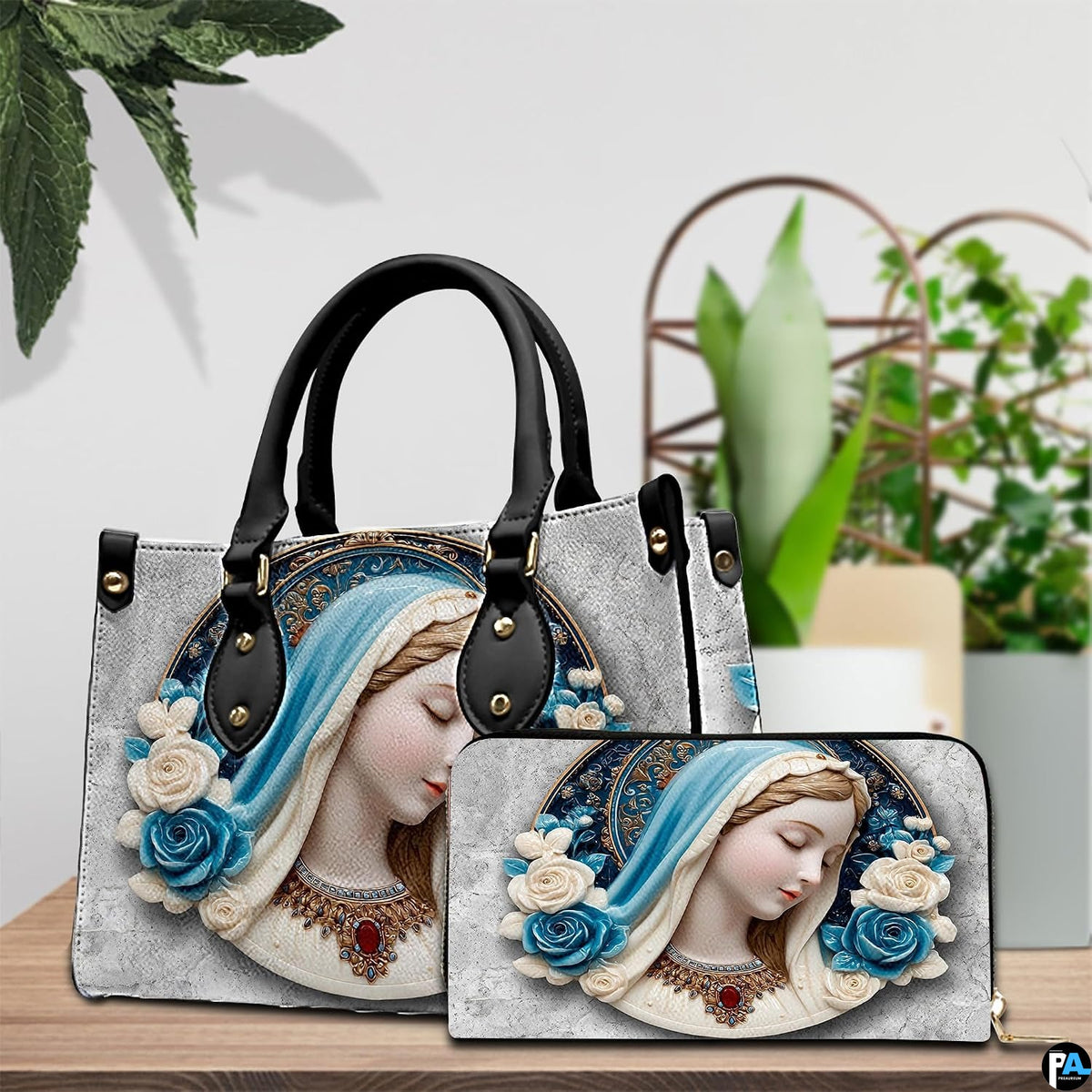 Virgin Mary cameo handbag and matching wallet styled together on wooden table
