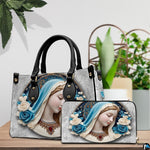 Virgin Mary cameo handbag and matching wallet styled together on wooden table