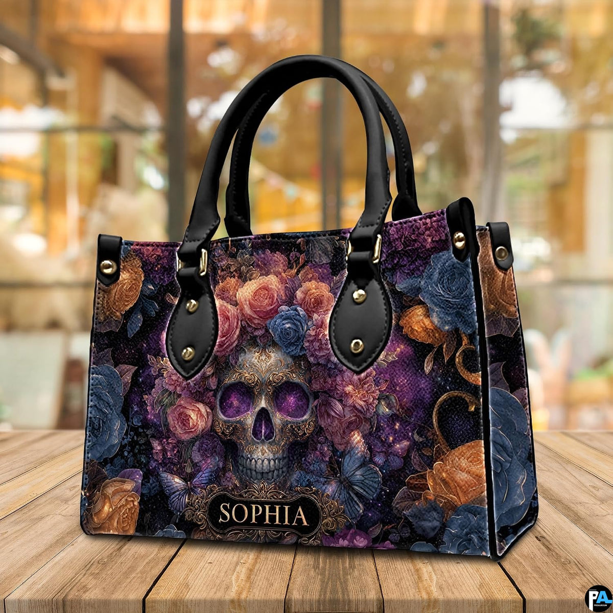 Cosmic skull floral handbag displayed on wooden plank table before indoor window.