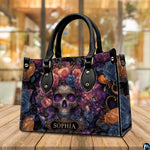 Cosmic skull floral handbag displayed on wooden plank table before indoor window.