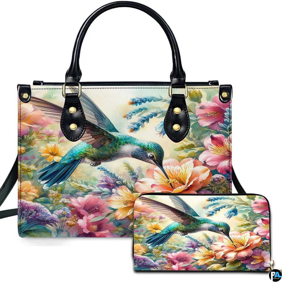 Front view of watercolor hummingbird handbag and matching wallet featuring colorful blooming wildflower art.