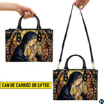 Handbag displayed showing top handle carry and shoulder wear positions