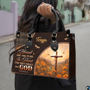 Side profile showing structured silhouette and brown textured finish of cross handbag.