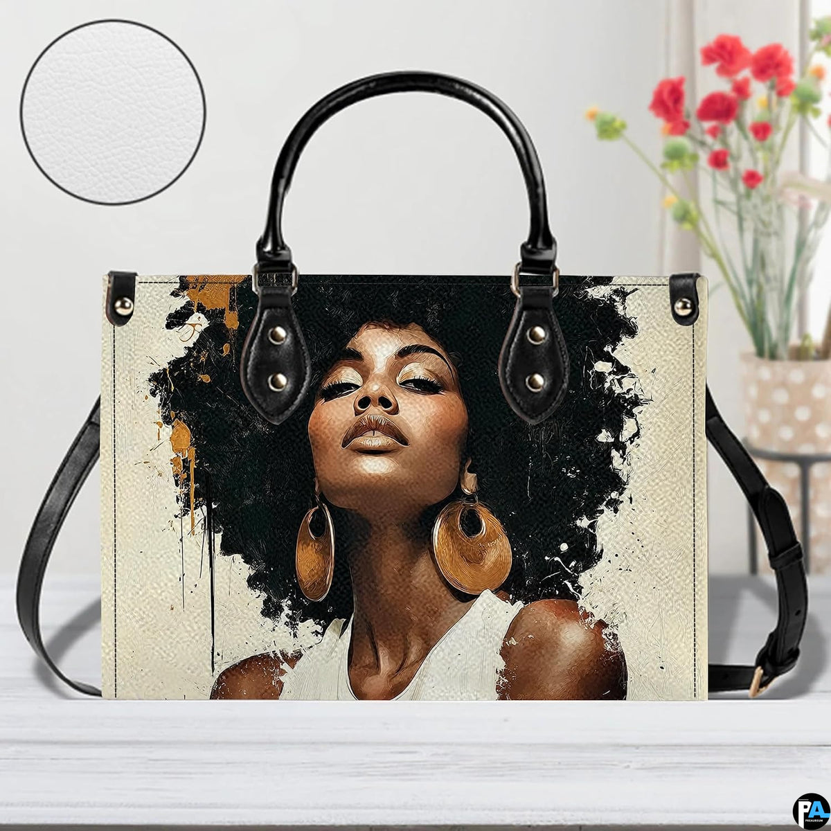 Front view of paint splash afro portrait handbag with black trim and gold accents