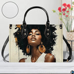 Front view of paint splash afro portrait handbag with black trim and gold accents