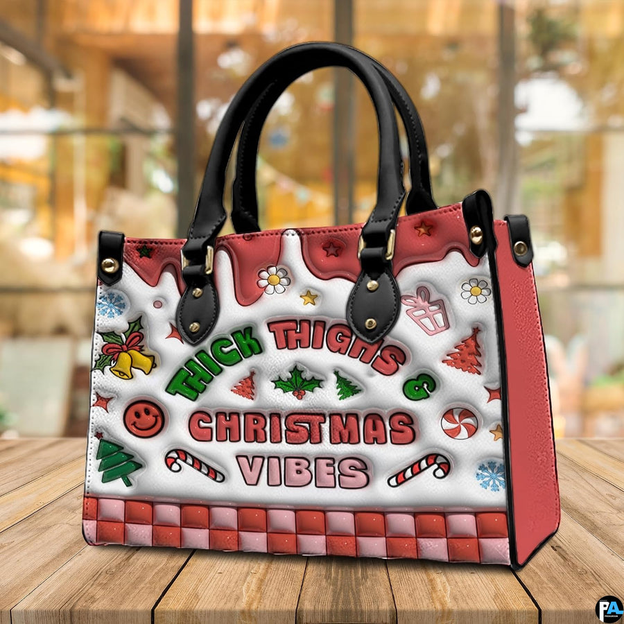 Holiday handbag displayed on a wooden table highlighting festive seasonal artwork and decorative details.