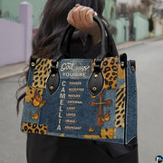 Street lifestyle view of Christian cross butterfly handbag held by hand on sidewalk