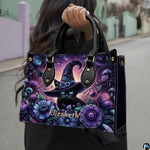 Outdoor perspective showing floral witch cat artwork held over arm by pedestrian along city sidewalk.