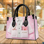 Back view of pink doctor handbag displaying textured pastel pink exterior surface