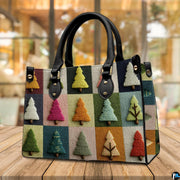 Tabletop view on wooden surface displaying vibrant patchwork holiday tree artwork.