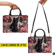 Side view highlighting dimensional relief black cat and floral artwork.