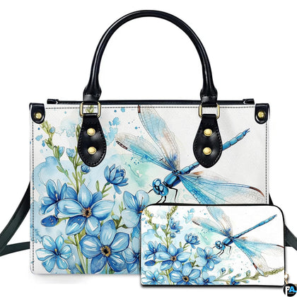 Watercolor blue dragonfly and forget-me-not floral handbag and wallet set displayed against a white background