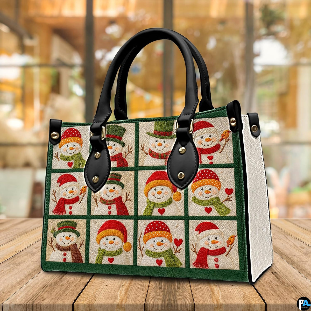 Lifestyle display of snowman patchwork handbag placed on a rustic wooden table in a brightly lit room.