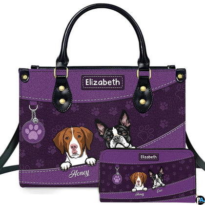 Front view of purple dog lover handbag and matching wallet featuring illustrated peeking pups and paw prints.