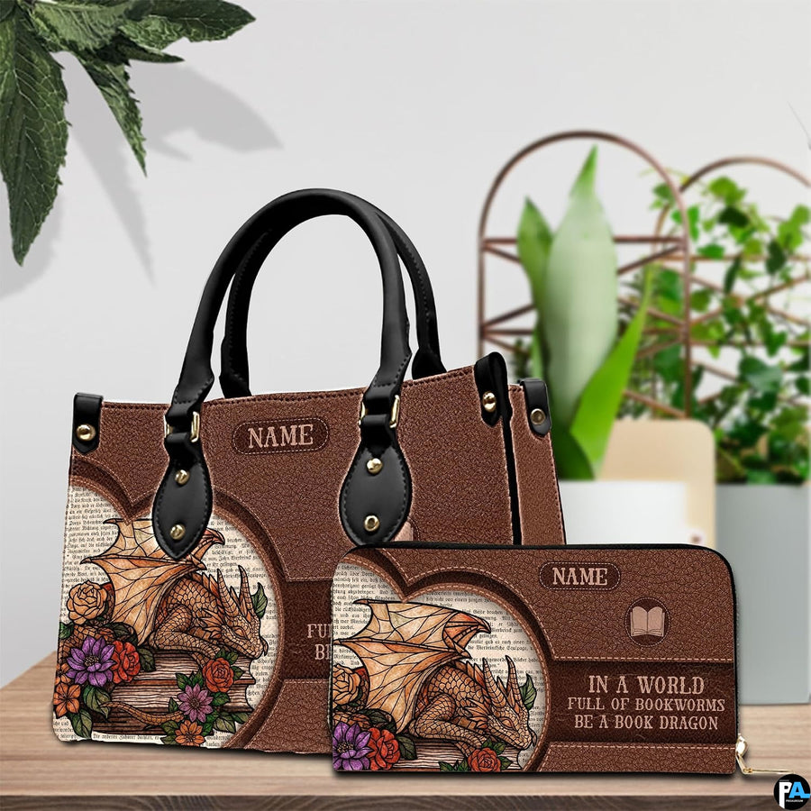Handbag displayed alongside matching zippered wallet with golden dragon and floral artwork on a table