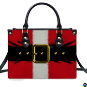 Frontal studio view of holiday handbag featuring Santa red coat graphic, white stripe, and golden belt buckle.