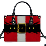 Frontal studio view of holiday handbag featuring Santa red coat graphic, white stripe, and golden belt buckle.