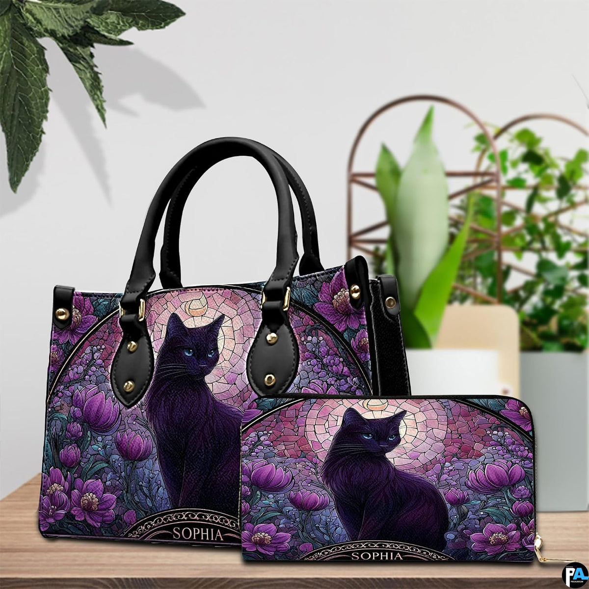 Tabletop arrangement showing stained glass black cat illustration paired with decorative green plants.