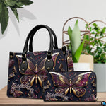 Close-up front view of handbag showing gold and plum butterfly wings