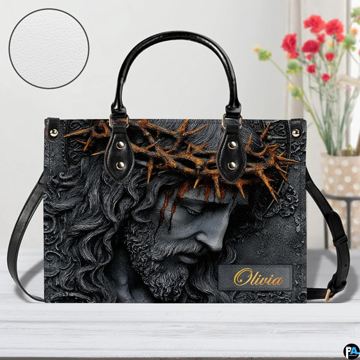 Side perspective view of Christ relief portrait handbag and wallet pair