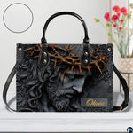 Side perspective view of Christ relief portrait handbag and wallet pair