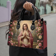 Angled view of Virgin Mary courtyard rose garden handbag