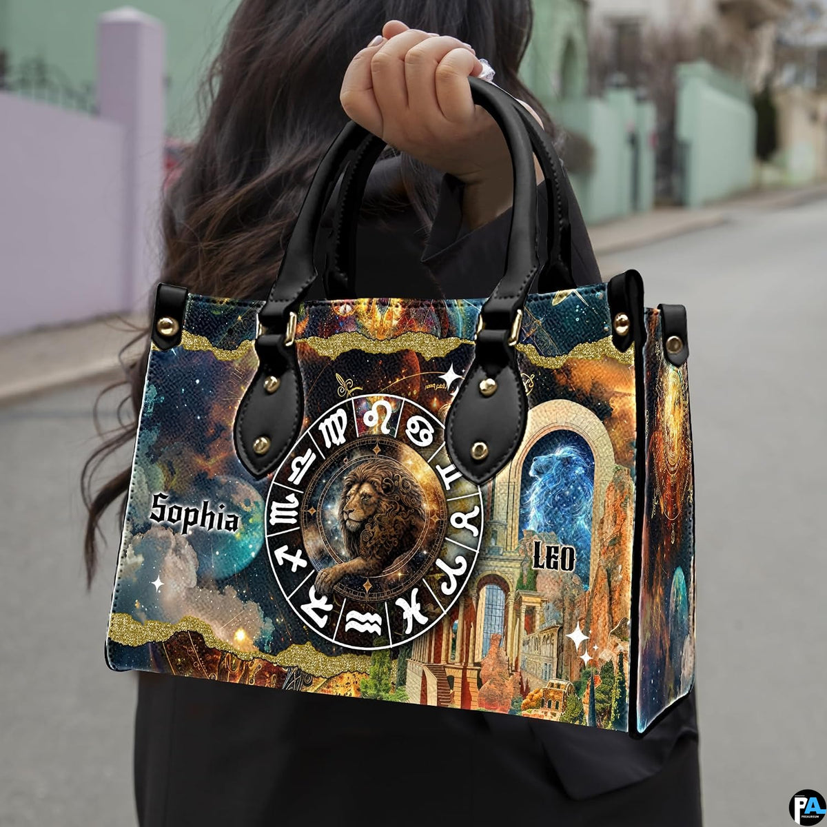 Woman carrying Celestial Lion Satchel Handbag outdoors by top handle on a city walkway.