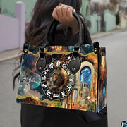 Woman carrying Celestial Lion Satchel Handbag outdoors by top handle on a city walkway.