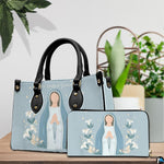 Minimalist Virgin Mary handbag and matching wallet styled together on wooden tabletop