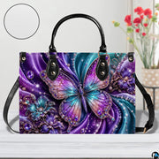 Close-up front view of matching zippered wallet showing crystal butterfly
