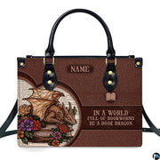 Front view of structured handbag featuring golden sleeping dragon, floral roses, and vintage printed book text