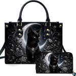 Studio view showcasing crowned black cat artwork alongside matching companion accessory on plain white surface.