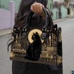 Black cat gothic art design showcased outdoors along a sunlit paved walkway.