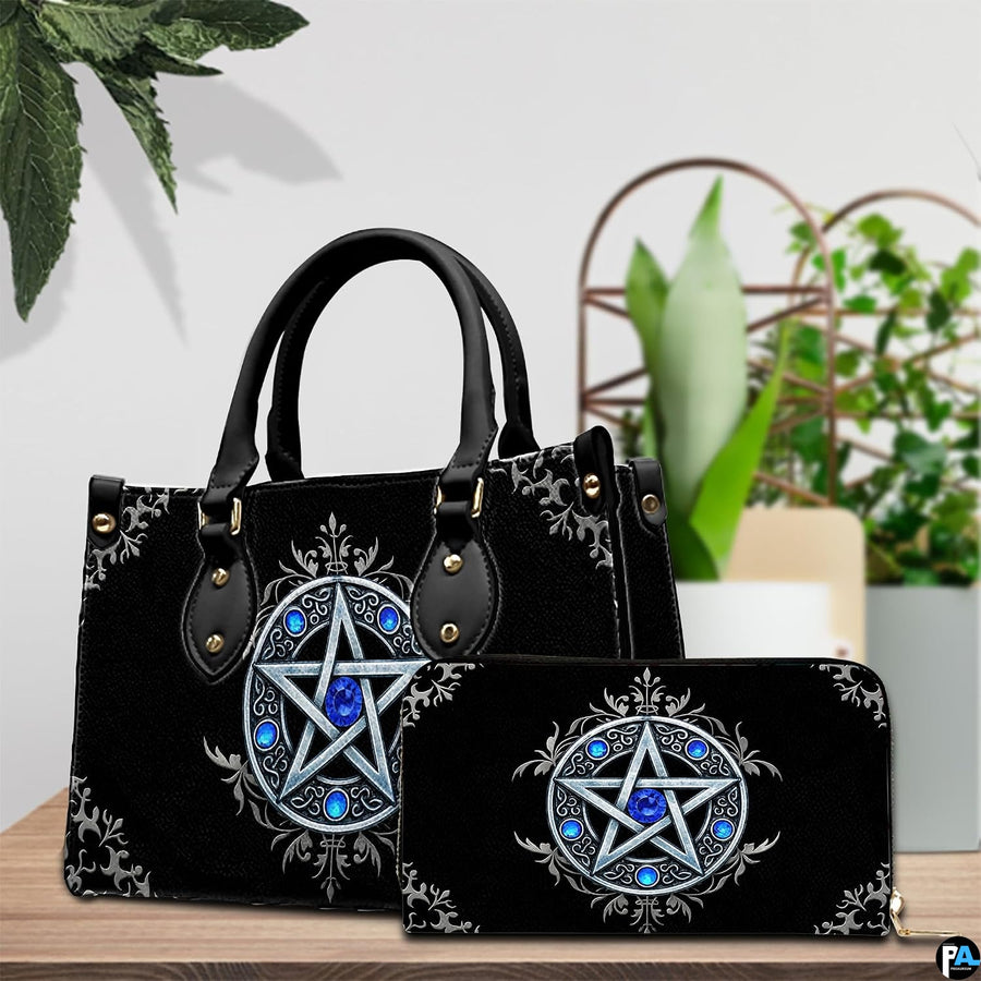 Gothic pentagram handbag and wallet on wooden table beside houseplant.