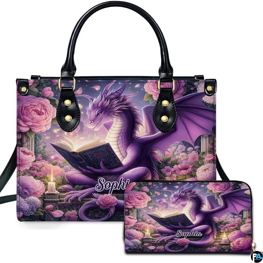 Studio front view of handbag and wallet set displaying purple dragon reading among pink peonies.