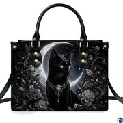 Front studio shot of crowned black cat, silver tiara, crescent moon, and monochrome roses.