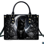 Front studio shot of crowned black cat, silver tiara, crescent moon, and monochrome roses.
