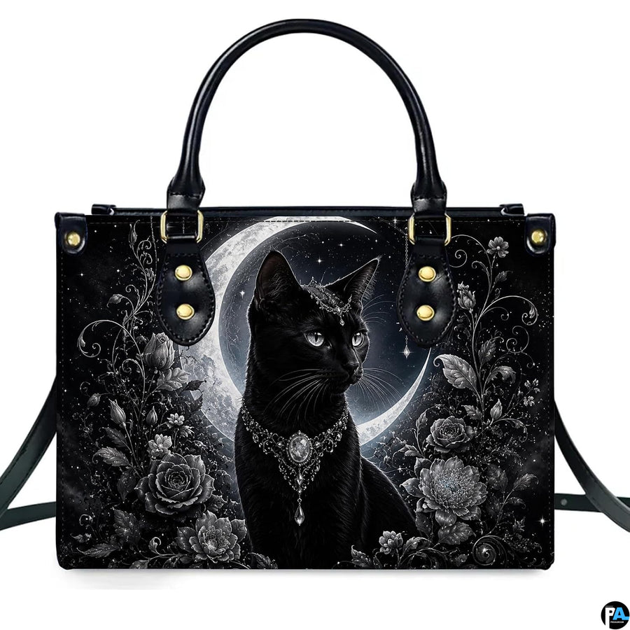 Front studio shot of crowned black cat, silver tiara, crescent moon, and monochrome roses.