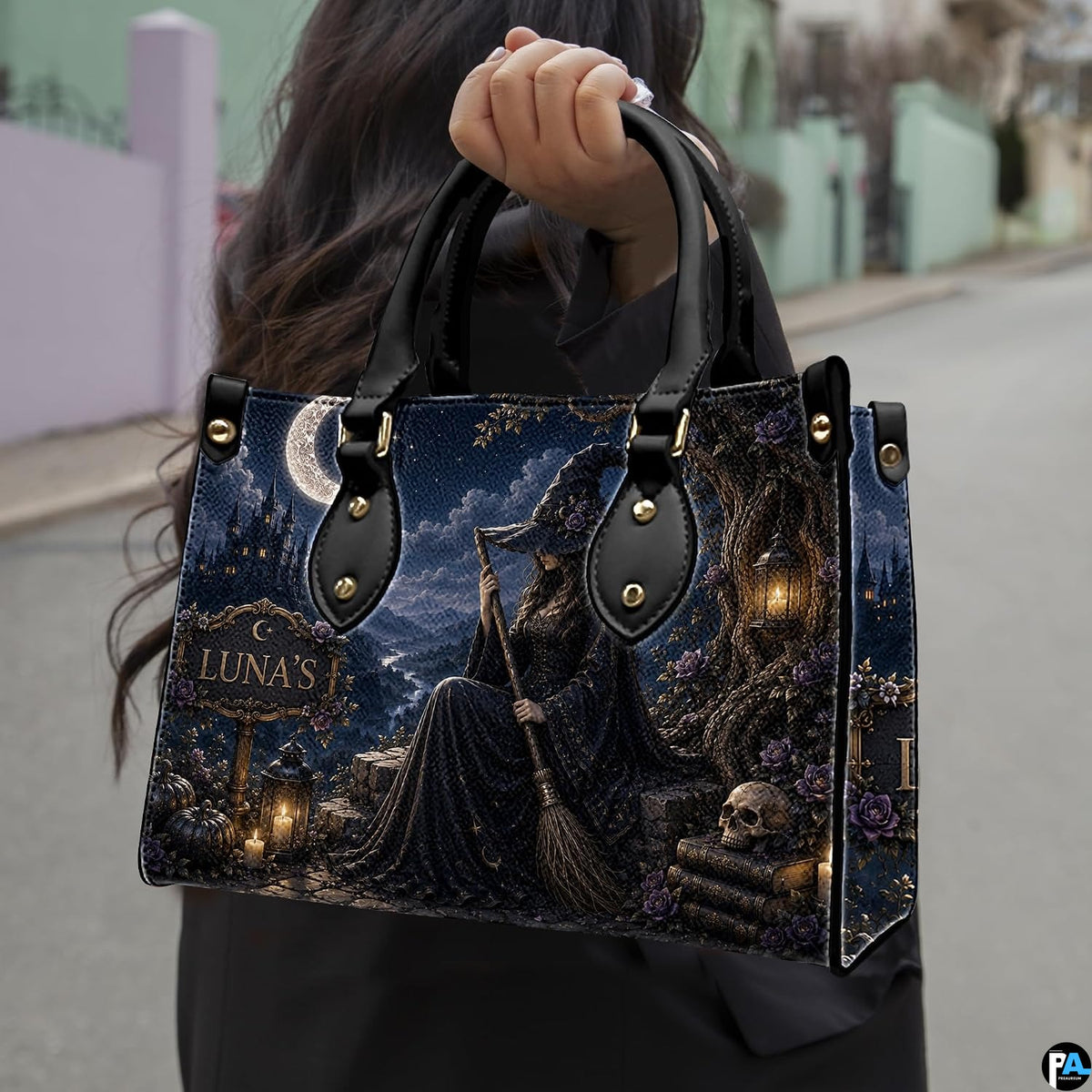 Street perspective of person holding the dark witch art accessory highlighting the seated sorceress motif.