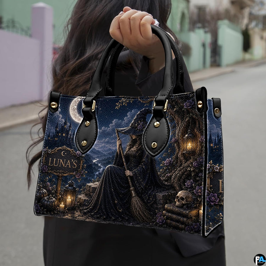 Street perspective of person holding the dark witch art accessory highlighting the seated sorceress motif.