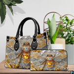 Back view of bee handbag displaying continuous silver and amber hexagonal honeycomb pattern.