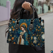 Madonna mosaic sacred art handbag held outdoors against an urban pavement and street background