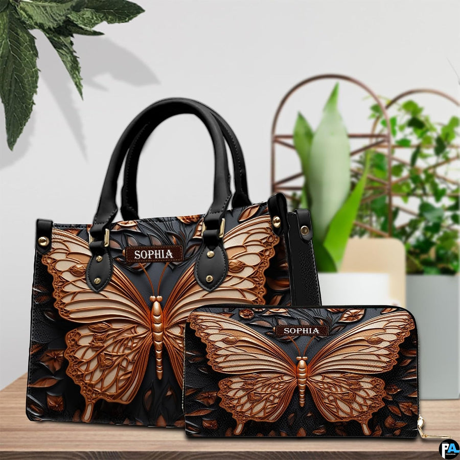Top-handle handbag and matching wallet displayed together beside potted houseplants.